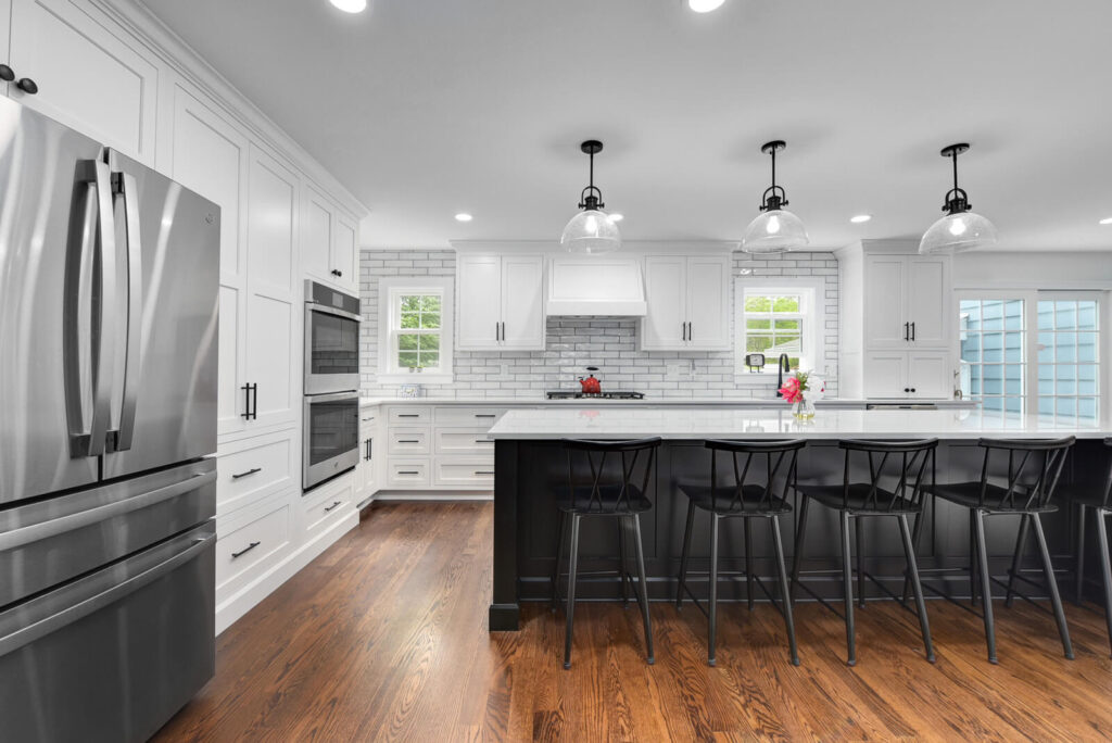 A modern kitchen featuring sleek white cabinets paired with elegant black countertops, creating a stylish contrast.