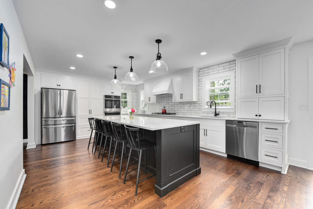 A modern kitchen featuring sleek white cabinets paired with elegant black countertops, creating a stylish contrast.