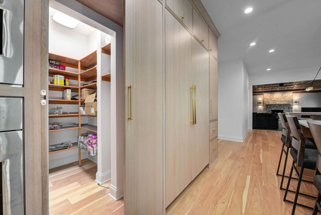 A modern kitchen featuring a spacious pantry and a stylish bar area for entertaining guests.