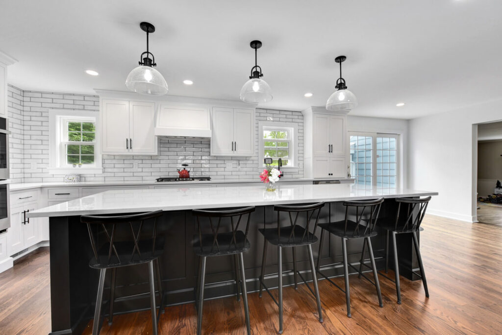 A stylish kitchen design with pristine white cabinets and bold black countertops, highlighting a modern aesthetic.