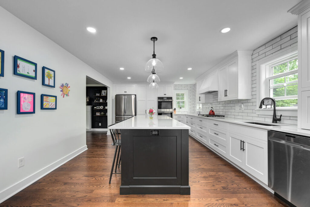 A modern kitchen featuring sleek white cabinets paired with elegant black countertops, creating a stylish contrast.