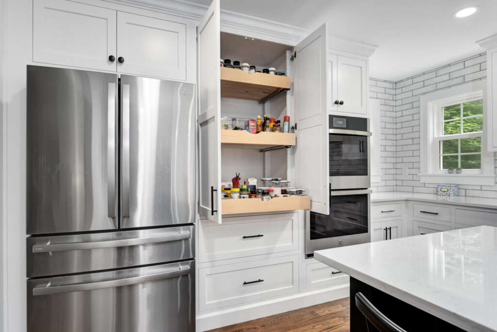 A contemporary kitchen showcasing white cabinetry and striking black countertops, offering a chic and sophisticated look.