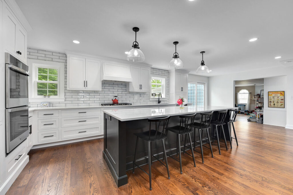 A contemporary kitchen showcasing white cabinetry and striking black countertops, offering a chic and sophisticated look.