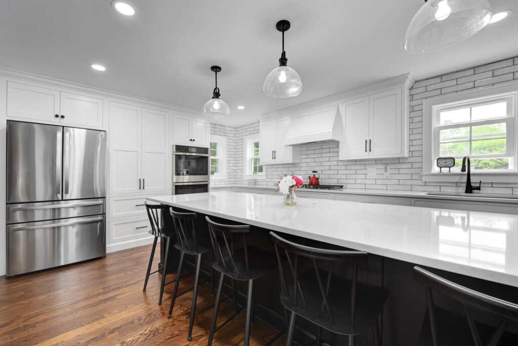 A modern kitchen featuring sleek white cabinets paired with elegant black countertops, creating a stylish contrast.