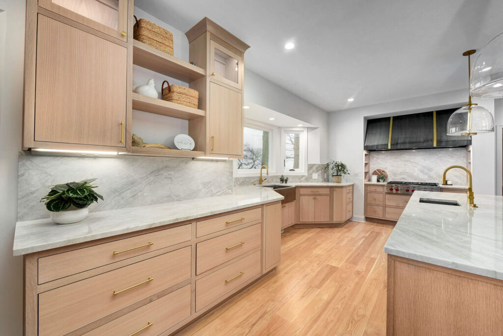 A modern kitchen featuring elegant wooden cabinets and sleek marble countertops, showcasing a stylish and functional design.